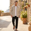 Men's relaxed button-front shirt with geometric pattern by FJØRNA, shown in a casual lifestyle setting.