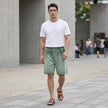 Men's casual knit shorts by FJØRNA with distressed finish, raw hem, and relaxed fit, shown in a lifestyle setting.
