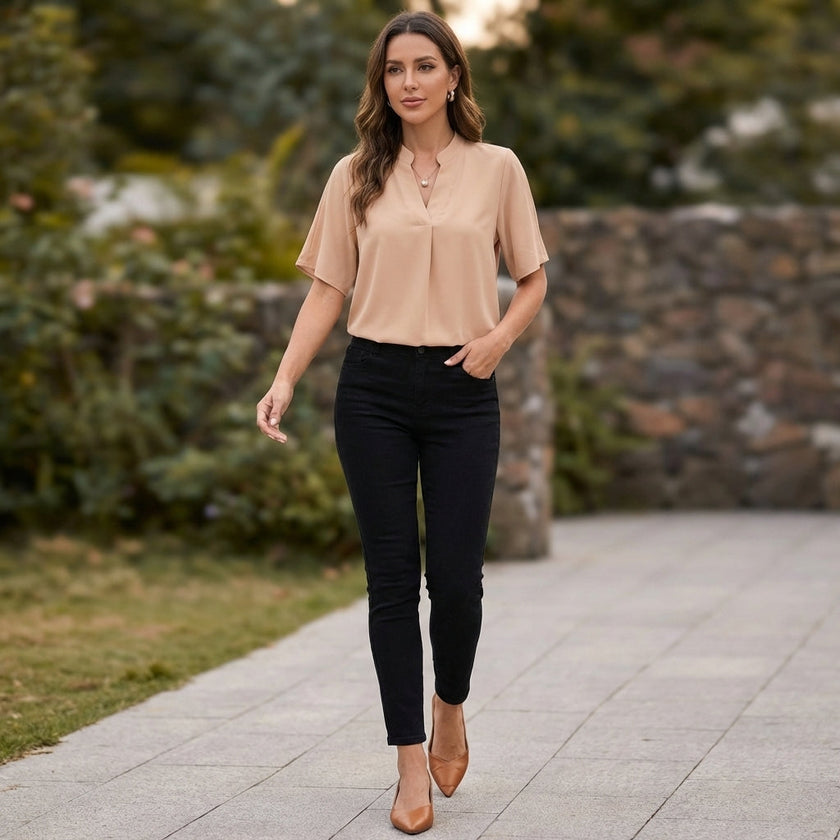 FJØRNA women's chiffon V-neck blouse with stand collar and split cuffs, styled in a casual outdoor setting.