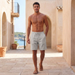 Men's casual drawstring shorts by FJØRNA with straight legs and side pockets, shown in a relaxed lifestyle setting.