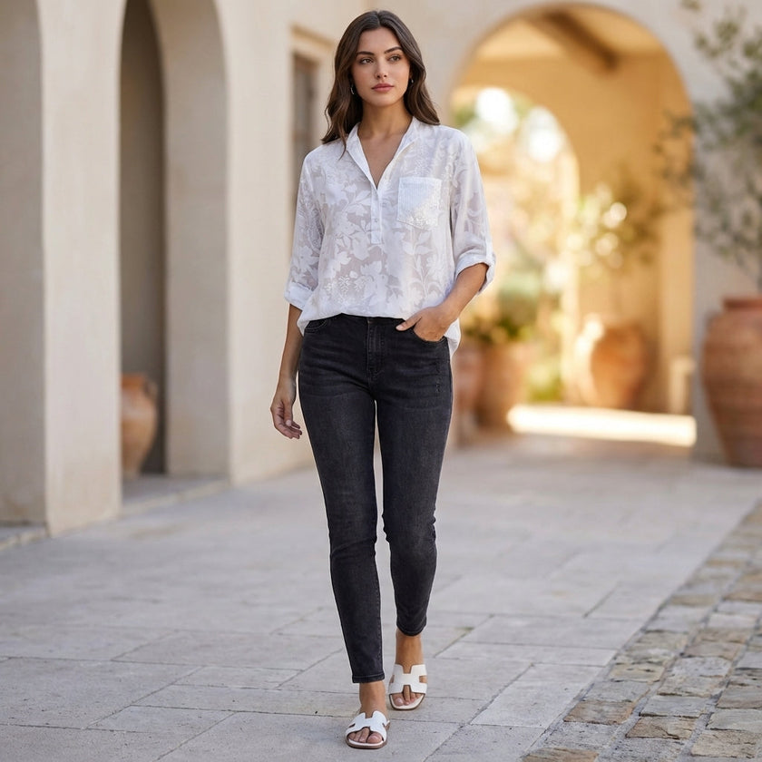 FJØRNA women's floral V-neck denim summer blouse worn casually, showcasing lightweight fabric and vibrant floral pattern.