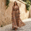 FJØRNA embroidered belted A-line maxi dress with collar, flowing silhouette, worn by a woman in a stylish outdoor setting.