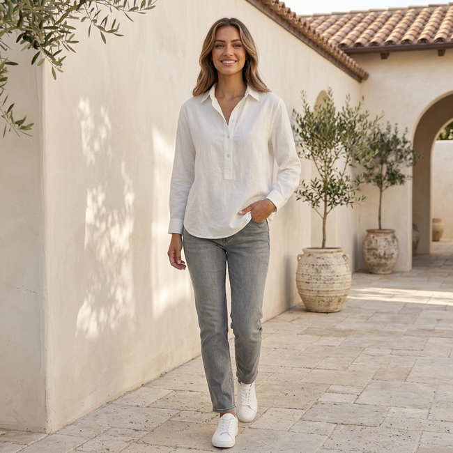 FJØRNA women's V-neck popover shirt with cuffed sleeves and a relaxed fit, styled casually in a lifestyle setting.