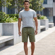 Men's casual work shorts by FJØRNA with green leaf print, belt, and relaxed fit, suitable for outdoor and everyday wear.