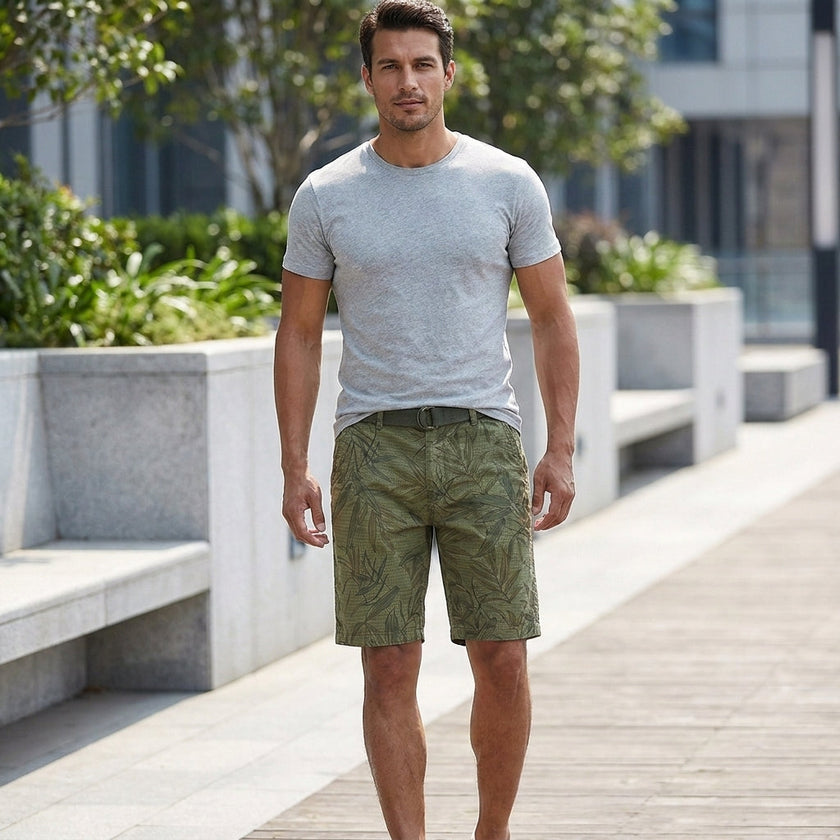 Men's casual work shorts by FJØRNA with green leaf print, belt, and relaxed fit, suitable for outdoor and everyday wear.