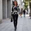 FJØRNA relaxed print blouse for women with collar and abstract pattern, styled as a casual top in a lifestyle setting.