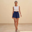 Women’s linen ruffle summer shorts by FJØRNA, casual lifestyle shot showing lightweight, flowy shorts perfect for warm weather.
