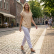 FJØRNA women's summer sleeveless V-neck blouse worn by a woman in a casual outdoor setting