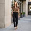 FJØRNA summer satin ruffle blouse for women, showcasing a stylish, flowy top with ruffle details worn in a casual lifestyle setting.