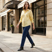 Women’s linen summer top by FJØRNA with button front, casual lifestyle shot showing lightweight, breathable fabric and relaxed fit.