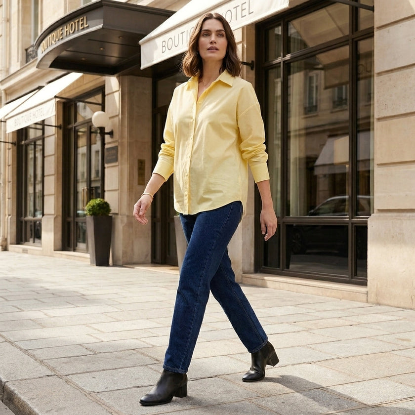 Women’s linen summer top by FJØRNA with button front, casual lifestyle shot showing lightweight, breathable fabric and relaxed fit.