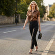 FJØRNA women's leopard print summer blouse with short sleeves, styled casually with a relaxed fit in a lifestyle setting.