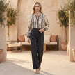 FJØRNA summer print V-neck blouse for women, casual top with floral pattern, worn outdoors in a lifestyle setting