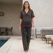 FJØRNA leopard print chiffon lounge set with relaxed wide-leg silhouette, featuring a two-piece design, styled in a casual home setting.