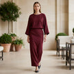 FJØRNA two-piece textured woven skirt suit with draped high-waist silhouette, shown in a stylish lifestyle setting.