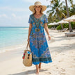 FJØRNA bohemian A-line scoop neck maxi dress for women, flowing fit with floral patterns, styled outdoors in a relaxed setting.