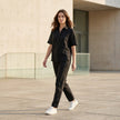 FJØRNA women's summer denim blouse with short sleeves, styled casually outdoors on a woman in a lifestyle setting.