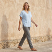 FJØRNA women's summer V-neck denim blouse with short sleeves, styled in a casual outdoor setting.