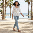 FJØRNA women's summer blouse with square neckline and lace details, stylish top for warm weather, shown in a casual outdoor setting