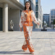 FJØRNA botanical zip-front top and wide-leg pants 2-piece set, featuring vibrant floral print and casual, stylish fit.