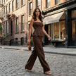 FJØRNA elegant peplum cami top and wide-leg trouser set worn by a model in a stylish lifestyle setting.
