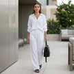 FJØRNA oversized two-piece crinkle-texture suit with relaxed fit and drawstring waist in a casual lifestyle setting