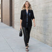 FJØRNA women's summer blouse with V-neck, denim fabric, button-front design, styled in a casual outdoor setting
