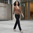 FJØRNA women's summer V-neck long sleeve denim blouse worn casually outdoors with rolled-up sleeves and relaxed fit.