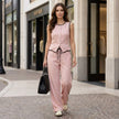 FJØRNA contrast trim two-piece set with relaxed wide-leg pants and matching top, styled in a casual lifestyle setting.