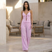 FJØRNA two-piece striped woven lounge set with spaghetti-strap tie top and wide-leg trousers, styled for relaxed comfort.
