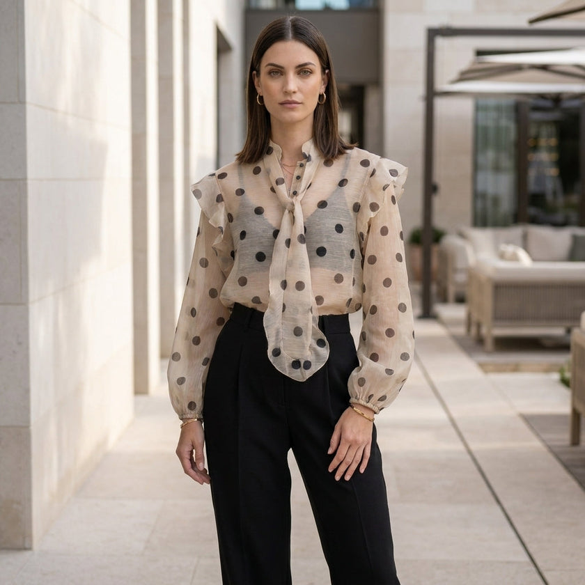 FJØRNA women's summer polka dot blouse with long sleeves, casual top worn in a relaxed lifestyle setting.
