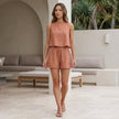 FJØRNA relaxed textured pleated two-piece set with button-front tank top and matching shorts, styled for casual wear.