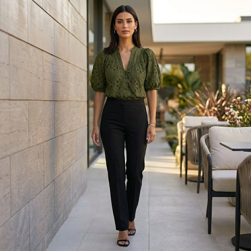 FJØRNA women's summer V-neck linen blouse with button front, casual style, worn as a stylish top in a relaxed lifestyle setting.