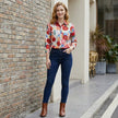 FJØRNA women's floral long sleeve denim blouse worn casually, showcasing its relaxed fit and vibrant floral pattern.