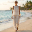 FJØRNA flowing semi-sheer two-piece set with draped wide-leg trousers, styled in a relaxed, elegant lifestyle scene.
