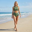 FJØRNA women's high neck high waist summer bikini in vibrant colors, worn by a woman on the beach.