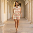 FJØRNA relaxed two-piece set with abstract geometric striped top and drawstring shorts, worn in a casual lifestyle setting