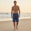 Men's casual knee-length chino shorts by FJØRNA with adjustable drawstring waist, styled for relaxed vacation wear.