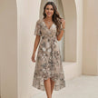 FJØRNA Sofia Amoretti flowy chiffon wrap midi dress with tie waist, styled casually in a lifestyle setting.