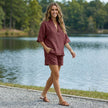 FJØRNA relaxed V-neck blouse and tailored short set worn by a woman in a casual outdoor setting.