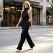 FJØRNA Celeste pleated halter top and wide-leg pant set worn by a model in a stylish outdoor setting.