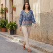 FJØRNA women's floral long sleeve linen summer blouse worn by a woman outdoors, stylish and lightweight for warm weather.