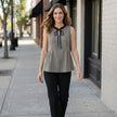 FJØRNA women's sleeveless gingham summer blouse styled with casual accessories, perfect for warm weather and outdoor wear.