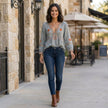 FJØRNA summer floral blouse for women featuring a flowy design and V-neck, styled in a casual outdoor setting.