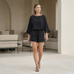 FJØRNA two-piece set featuring eyelet lace trim and relaxed silhouette, perfect for casual or stylish everyday wear.
