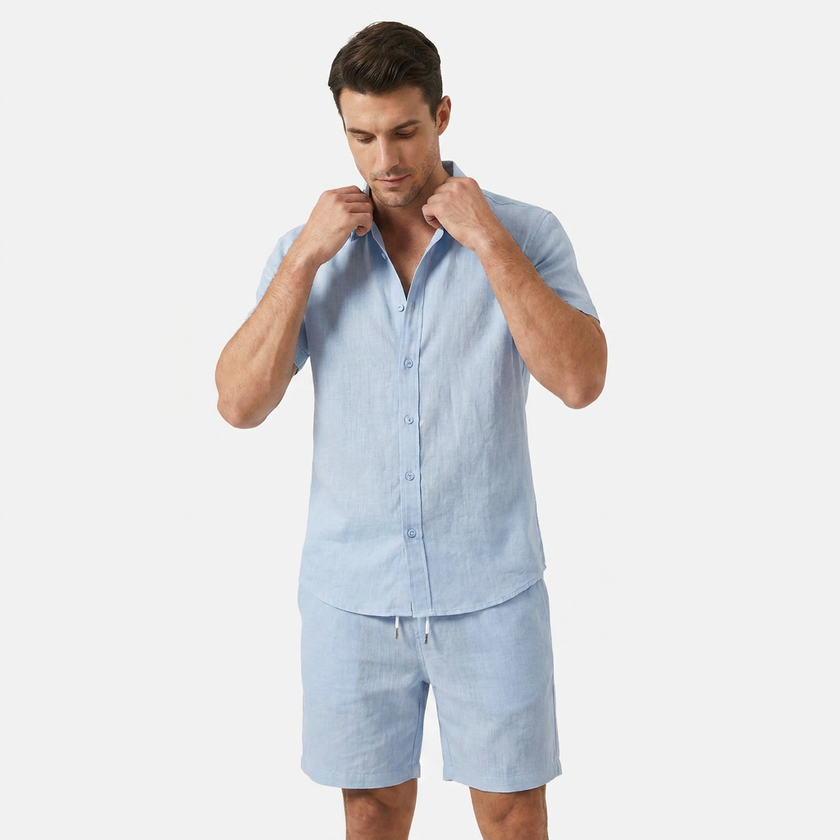 Light blue men's linen two-piece set by FJØRNA, featuring a buttoned short sleeve shirt and matching shorts.