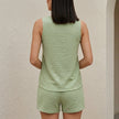 Light blue FJØRNA relaxed sleeveless button-front lounge set, 2-piece pajama set on a hanger, comfortable and stylish lounge wear.
