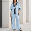 Light blue coastal chic contrast trim top and wide-leg pants set by FJØRNA, stylish 2-piece ensemble perfect for warm weather.