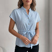Light blue FJØRNA summer women's blouse with cap sleeves, denim fabric, stylish top for warm weather.