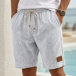 Light gray men's casual drawstring shorts with pockets and elegant accents, styled for comfortable everyday wear by FJØRNA.